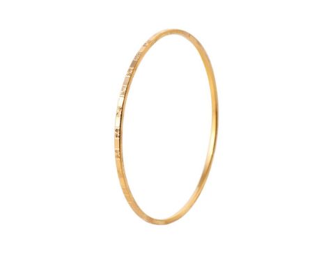Yellow metal (tests as 18ct or better) circular bangle with engraved decoration, 62mm diameter, 11 grams.  