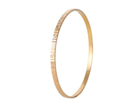 Yellow metal (tests as 18ct or better) circular bangle with engraved decoration, 61mm diameter, 11.1 grams.  
