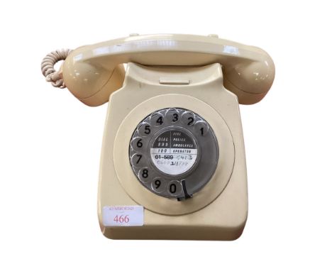A vintage bakelite cream dial telephone. 