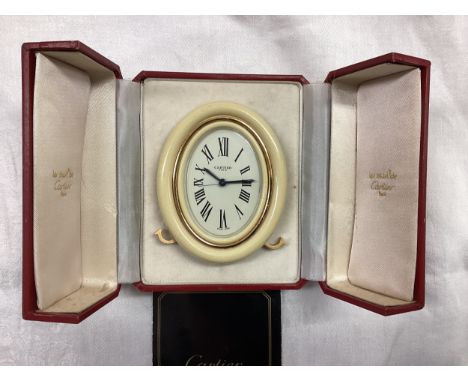A 9ct gold garnet 3 stone ring 3.2g, and a  Cartier alarm clock in original red Cartier presentation box.
