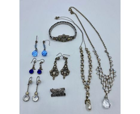 An unmarked white metal Art Deco Style cocktail watch, set with paste stones, and a paste set bracelet and chandelier earring