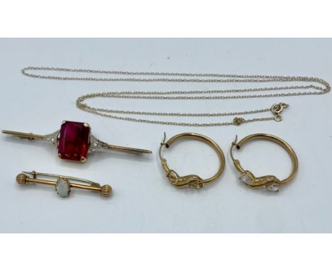A 9ct gold and platinum bar brooch, set with central synthetic spinel and brilliant cut diamond accents, 6.5cm, and an unmark