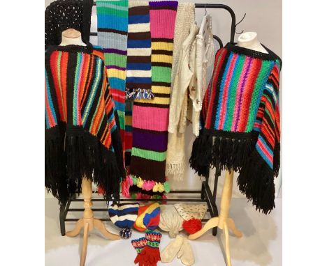 A quantity of vintage C20th hand knitted items to include two ponchos, shawl, jumper, cardigan, and various hats gloves and s