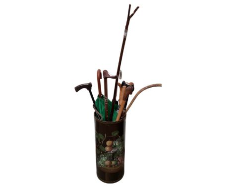 A decorative floral stick stand, with a quantity of sticks.