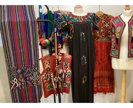 A quantity of embroidered and Mexican clothing to include a black cotton embroidered dress labelled Made in Mexico, a red emb