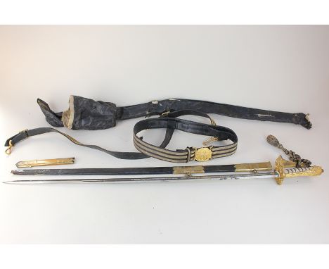 A Naval Officers sword, the blade marked Gieves, with fouled anchor and Royal coat of arms, in brass and black leather scabba