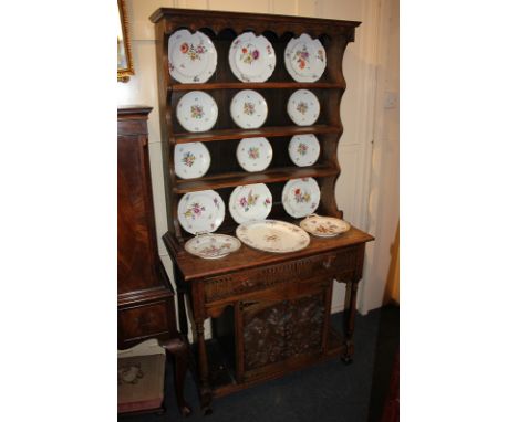 An early 20th century small oak Welsh dresser with three-shelf back, on base with single drawer, carved cupboard doors and tu