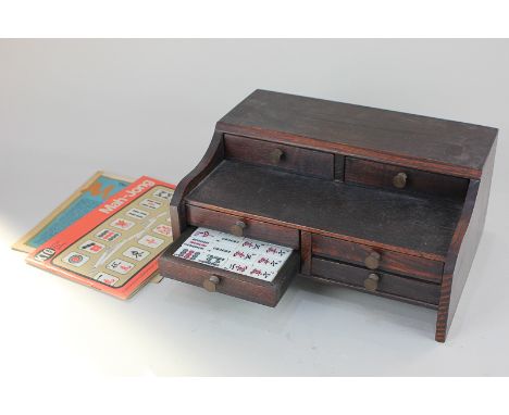 A mahjong set in wooden cabinet with instructions and booklet, 28cm