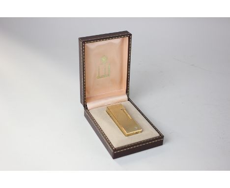 A Dunhill gilt metal rectangular lighter with engine turned decoration, boxed