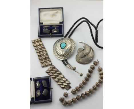 A Mexican silver and turquoise pendant on a plaited leather band, a feather lapel clip, two silver bracelets, two pairs of si