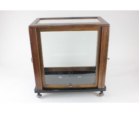 A mahogany and glass case, with sash front and two side doors, on marble base (previously holding laboratory scales or chemic
