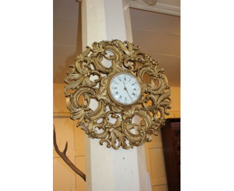 A Jaeger wall clock with ornate gilt floral scrolling surround, 54cm diameter