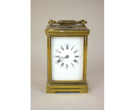 A brass and bevelled glass cased carriage clock, the movement half striking on a gong, 15.5cm high