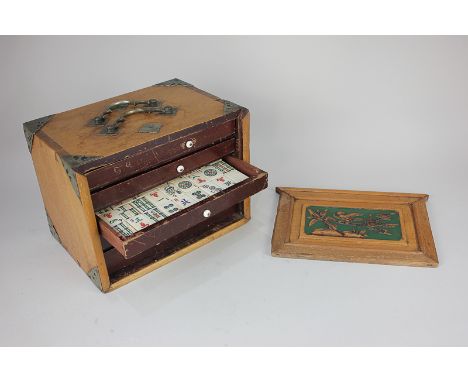 A bone and bamboo mahjong set in metal bound box with carved lid, box measures 17.5cm by 24cm, with rule book