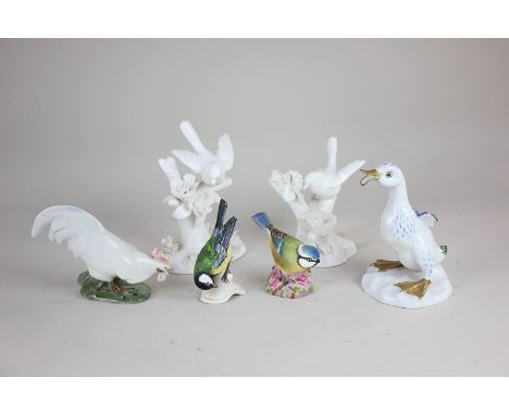 Two Crown Staffordshire white porcelain models of birds in branches, designed by J T Jones, 13cm, a Copenhagen model of a coc