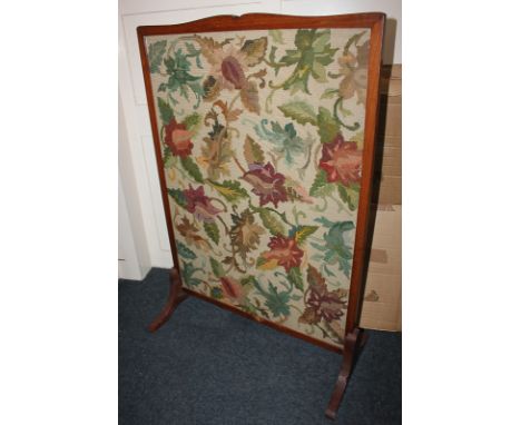 A glazed tapestry fire screen, foliate design within mahogany frame, 71cm