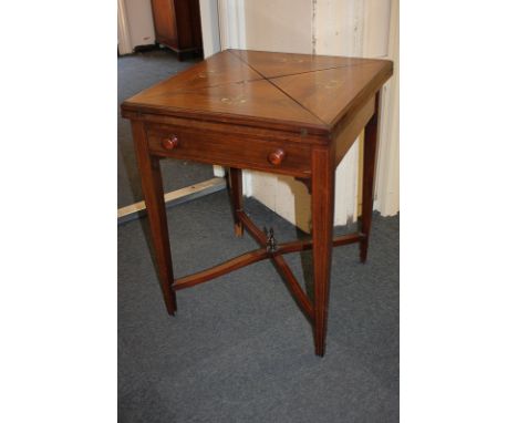 An Edwardian inlaid rosewood envelope card table with fold-out square top enclosing green baize interior and counter dishes, 