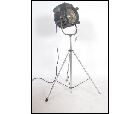 A good 20th century large theatre / cinema film spot light lamp on raised tripod having large cylindrical body with plaque fo