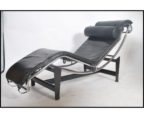After Le Corbusier LC4 chaise lounge day bed with black leather upholstery and barrel cushion set over a shaped chromium plat