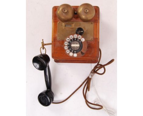A vintage 20th century Wooden cased GPO telephone with ring dialer and original handset. THe rear of the case marked for seri