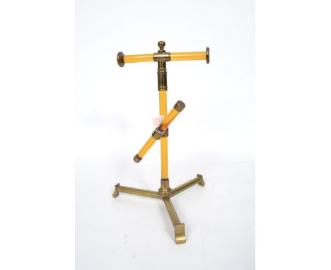 A stunning and unusual mid century brass and amber coloured glass haberdashery shop counter display stand. Tripod base with u