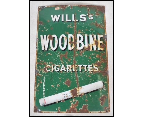 An original early 20th century enamel advertising sign for Wills Woodbine Cigarettes The sign  having a  smoking cigarette wi