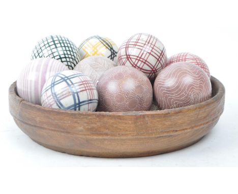 Collection of 19th century Victorian ceramic polished and stoneware boules in an elm wood rustic bowl. Four purple stone boul