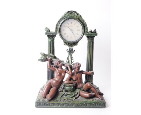 Late 20th century resin bronze classical style mantel clock. Clock depicting two male and female nude classical figures drape