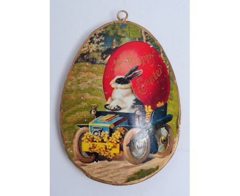 Vintage late 20th century Easter egg decoration. Featuring a meal egg shaped hanging decoration with a Bunny riding a tractor