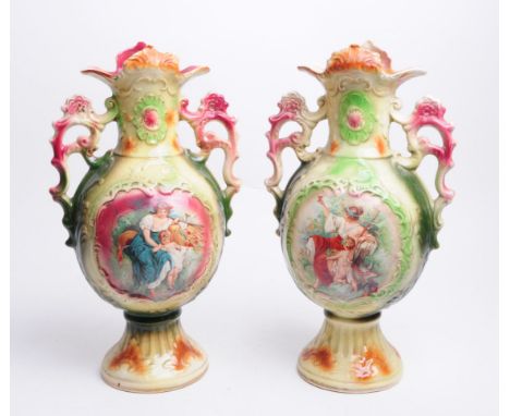 Strasburg Ware - Two Edwardian twin handled ceramic vases, both with mother and child vignettes to the centre front. Majority