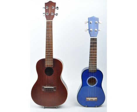 Tanglewood ukulele string musical instrument. Together with an electric blue Lazy ukulele. Model number TU - 4223. Both with 