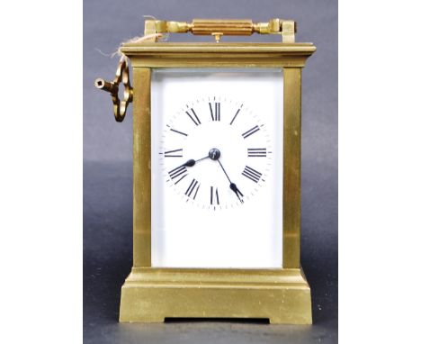 20th century brass carriage clock with beveled glaze front, sides and top. Features a Roman numeral chapter ring, white ename