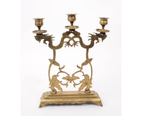 An early 20th century 1920s Chinese stamped brass candelabra. The candelabra featuring three candle holders to top, raised on