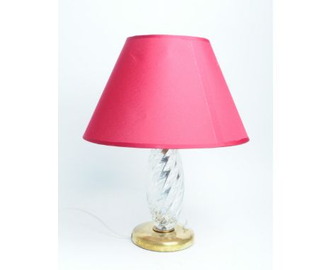 An Italian 1960s Murano clear glass and brass based table lamp with a red conical shade. Measuring approx. 38.5cm tall.