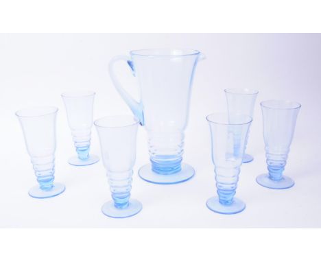 A vintage mid 20th century blue glass lemonade set. To consist of six glasses, alongside a pitcher. Each raised on a rounded 
