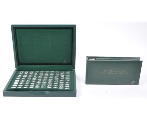 John Pinches Ltd - 1975 limited set of The 100 Greatest Cars Silver Miniature Collection housed within a green case and accom