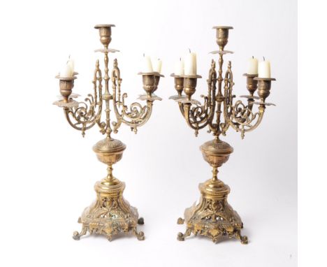 Two Victorian late 19th century brass garniture candelabra. Both features ornate detailing, four arms with candlestick holder