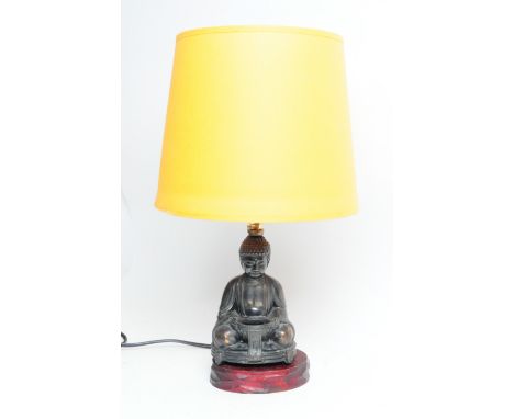 1950s Japanese copper Buddha shaped lamp base with yellow shade. Buddha mounted on a carved wooden base. Measuring approx. 39