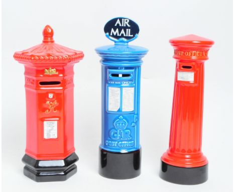 Collection of three ceramic money boxes / piggy banks in the form of Royal Mail post boxes. In typical form post box red colo