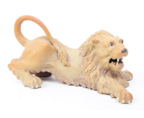A mid 20th century circa 1960s Chinese Cantonese ceramic lion figure. The lion in recumbent position with splayed front legs.