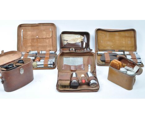 A large collection of vintage 20th century travelling case vanity sets. Seven in total in the brown leather case, with hair b