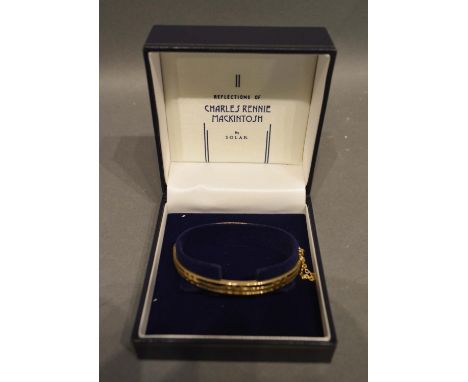 In The Style Of Rennie Mackintosh A 9ct. Gold Pierced Bangle, 9g 