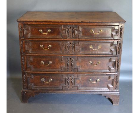 A 17th Century Oak Chest With Four Moulded Drawers and brass handles, raised upon bracket feet, 112cm wide, 57cm deep, 99cm h