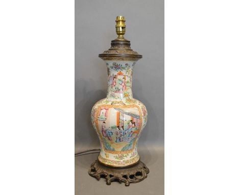 A 19th Century Canton Table Lamp Decorated In Polychrome Enamels with figures and with gilt metal mounts, 45cm tall 