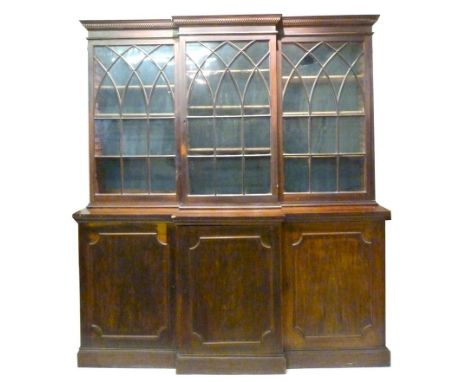 A George III Mahogany Breakfront Book Case, The Moulded Top above three arched glazed doors, the lower section with three pan