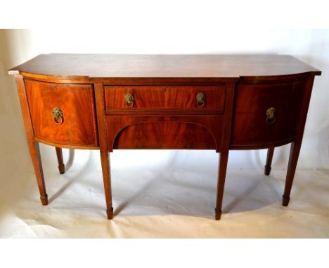 A 19th Century Mahogany Semi-Bow Fronted Sideboard With Two Central Drawers, flanked by cupboard doors with lion mask ring ha