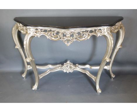 A French Silvered Console Table The Serpentine Marble Top Above A Pierced Frieze, raised upon cabriole legs with scroll feet,