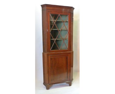 A 19th Century Mahogany Standing Corner Cabinet, The Moulded Cornice above an astragal glazed door enclosing shelves, the low