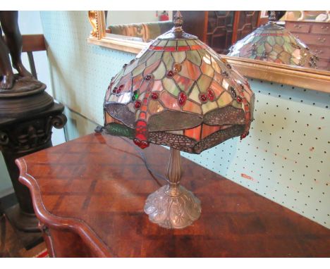 An Art Deco-style table lamp, the Tiffany-style shade depicting dragonflies and inset stones on a white metal base, 48cm.