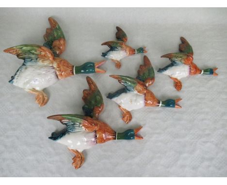 A set of five graduated ceramic Beswick flying ducks, no. 596, the largest 29cm wide. Condition Report: No visible signs of d